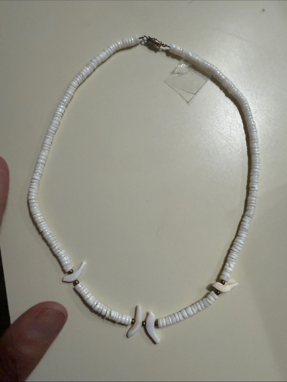 vintage white shell necklace features hand-carved bird fetishes